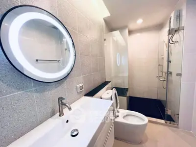 Modern bathroom with sleek fixtures and illuminated mirror