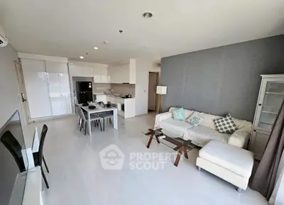 Modern open-plan living room with stylish kitchen and cozy seating area.