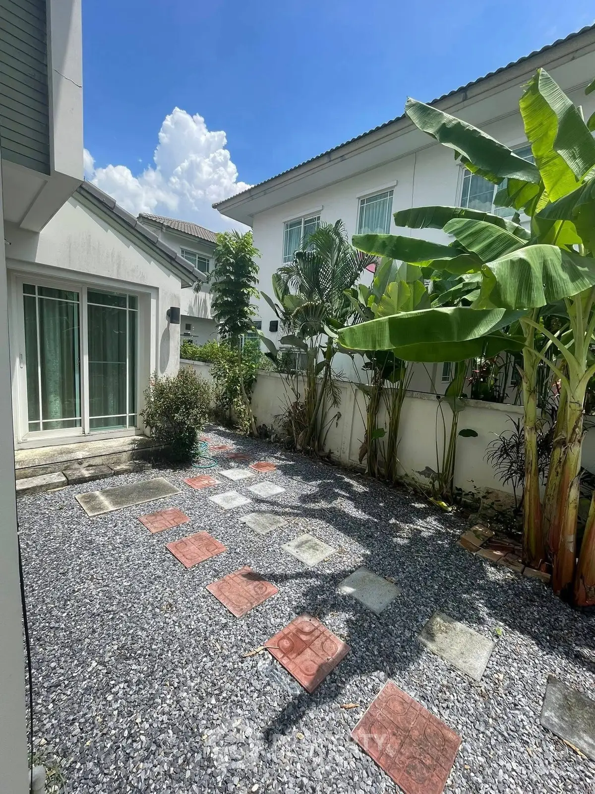 Charming garden area with stepping stones and lush greenery in a modern residential property.