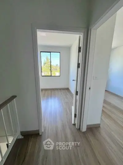Bright and airy interior with wood flooring and large windows in modern home.