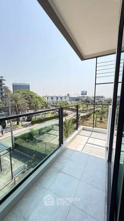 Spacious balcony with city view in modern apartment building