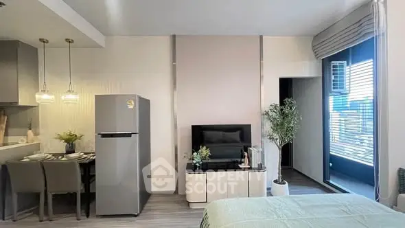 Modern studio apartment with open layout, featuring a sleek kitchen, cozy dining area, and stylish living space.