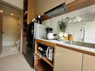 Modern kitchen with sleek cabinetry, stainless steel appliances, and stylish open shelving.
