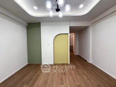 Modern minimalist living room with unique wall design and elegant lighting