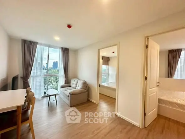 Modern apartment living room with city view and cozy furnishings