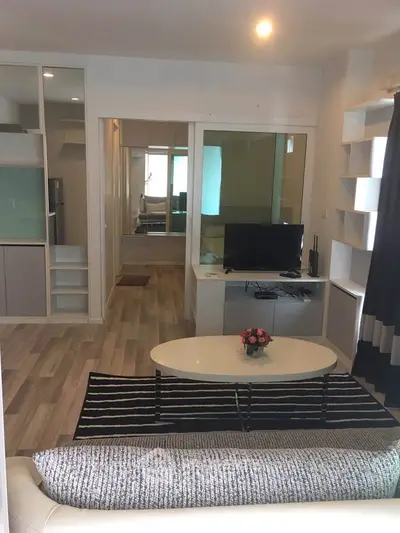 Modern living room with sleek design, featuring a cozy sofa, stylish coffee table, and a flat-screen TV.