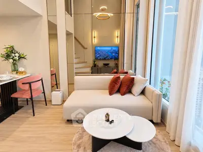 Luxurious modern living room with high ceilings and elegant decor in a stylish apartment.