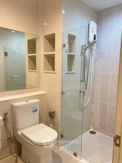 Modern bathroom with glass shower and sleek fixtures in a contemporary apartment.