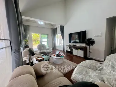 Spacious living room with modern decor and large windows for natural light.