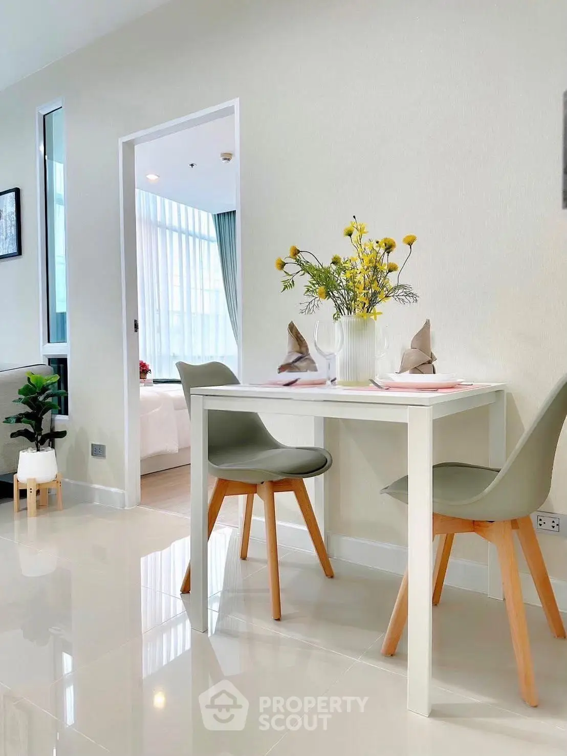 Modern dining area with elegant decor and natural light in a stylish apartment