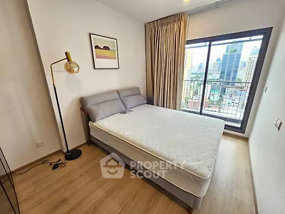 Modern bedroom with city view and stylish decor in high-rise apartment