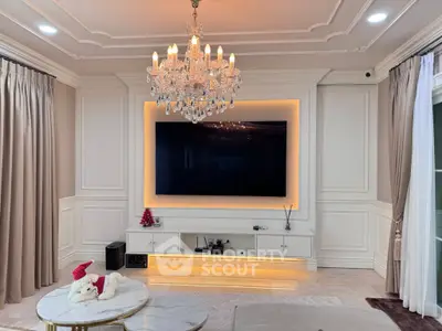 Luxurious living room with elegant chandelier and modern TV setup