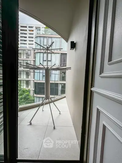 Modern balcony with city view and drying rack, perfect for urban living.