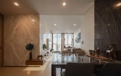 Luxurious modern living room with elegant decor and stunning city view from large windows.