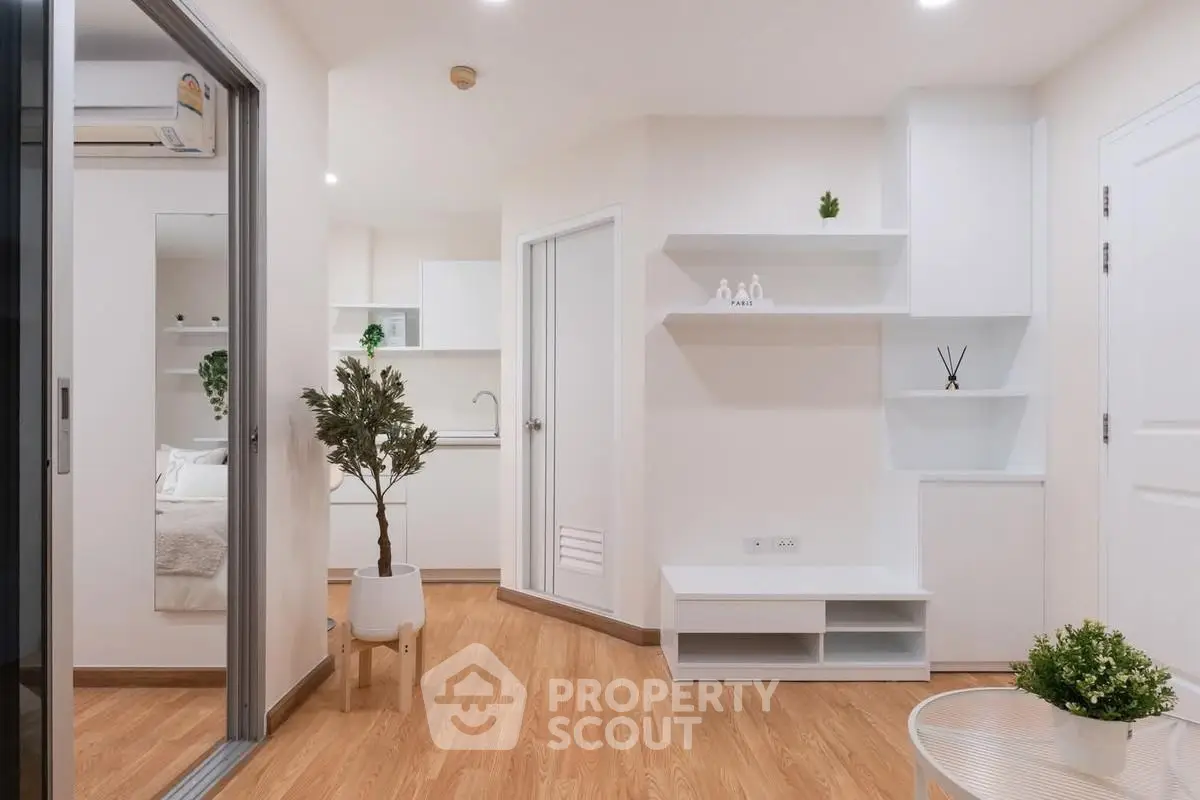 Modern minimalist apartment interior with wooden flooring and white furniture