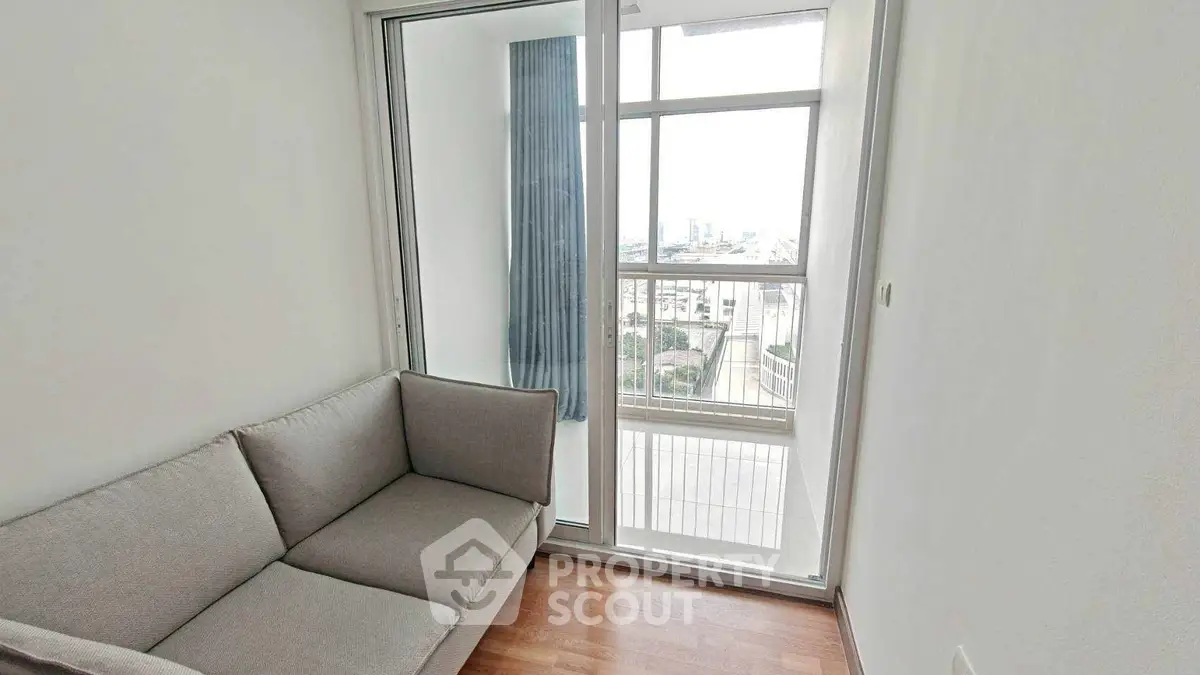 Cozy corner unit with a view, featuring a comfortable sofa and large windows.