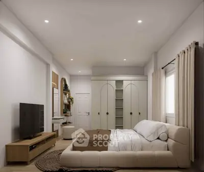 Spacious modern bedroom with elegant decor and ample natural light