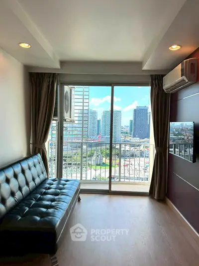 Modern living room with city view, leather sofa, and large windows in a high-rise apartment.