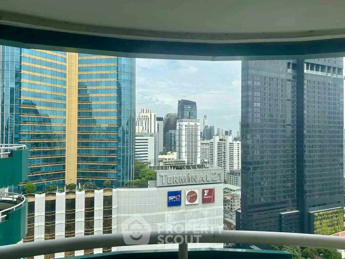 Stunning cityscape view from a high-rise balcony overlooking modern skyscrapers.