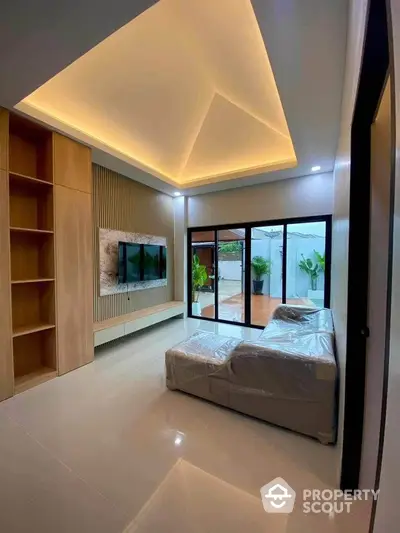 Modern living room with high ceiling and large windows overlooking patio