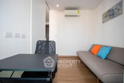 Modern small living room with sofa, desk, and air conditioning