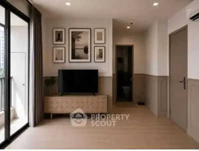 Modern living room with stylish decor and balcony access in a contemporary apartment.