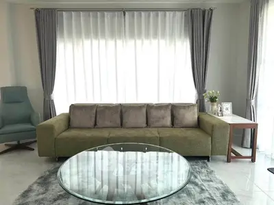 Elegant living room with modern sofa, glass coffee table, and stylish decor.