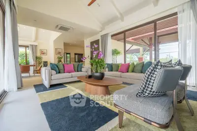 Spacious living room with modern decor and large windows offering natural light.