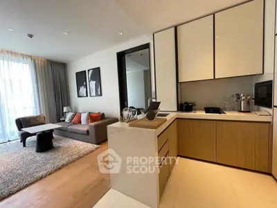 Modern open-layout living room and kitchen with stylish decor and natural light