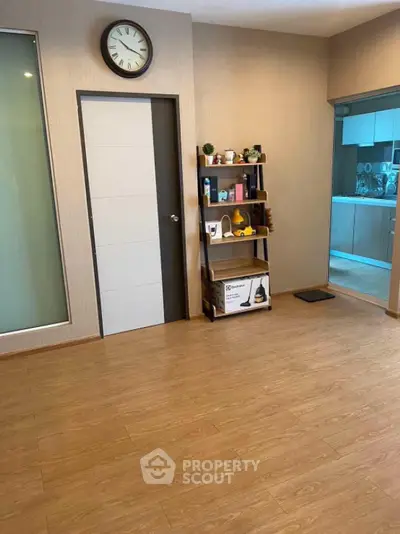 Modern interior with wooden flooring and stylish shelving unit in a cozy living space.