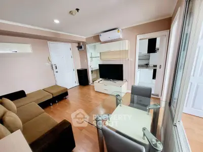 Modern living room with stylish furniture and open kitchen layout in a cozy apartment.