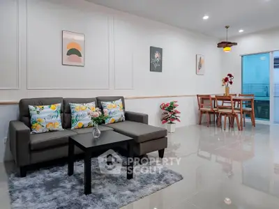 Spacious modern living room with stylish decor and dining area, perfect for entertaining.