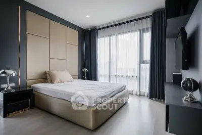 Luxurious modern bedroom with elegant decor and large window offering natural light.
