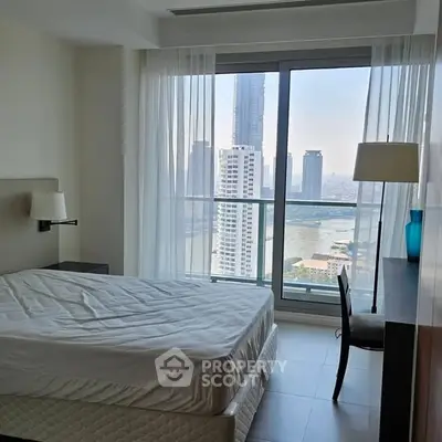 Modern bedroom with stunning city view and natural light through large windows.
