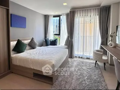 Modern bedroom with large windows and stylish decor in a luxury apartment.