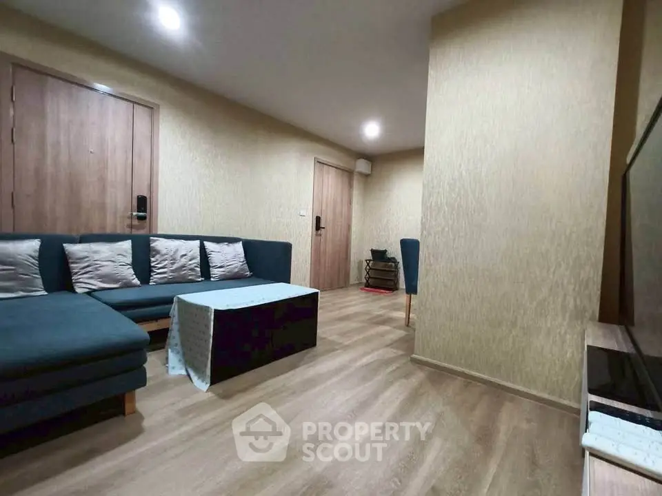 Modern living room with cozy sectional sofa and wooden flooring