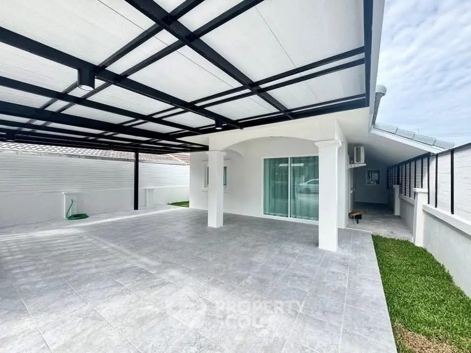 Spacious modern carport with sleek design and ample parking space.
