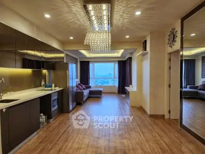 Luxurious open-plan living room with modern kitchen and stunning city view.