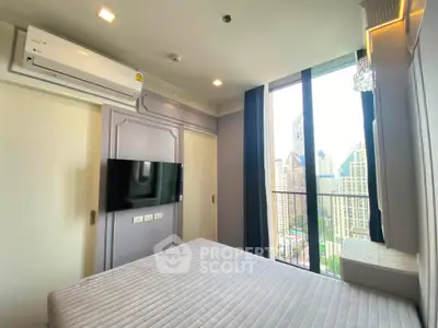 Modern bedroom with city view and balcony access in high-rise apartment