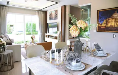 Luxurious open-plan living and dining area with elegant decor and natural light.
