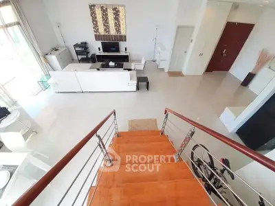 Spacious modern living room with elegant staircase and stylish decor