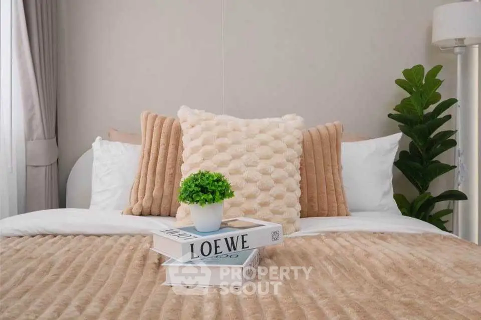 Cozy bedroom with plush pillows and stylish decor, perfect for relaxation and comfort.
