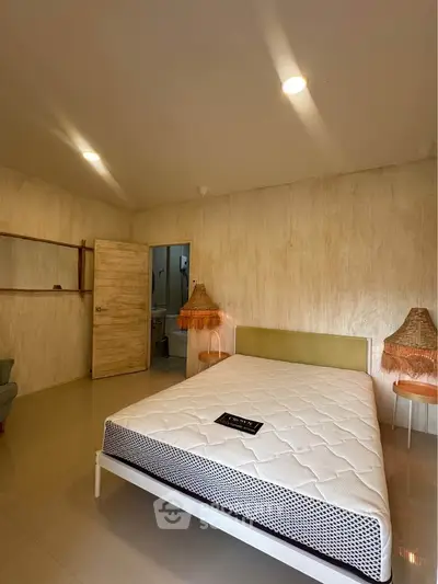 Spacious bedroom with modern decor and cozy lighting