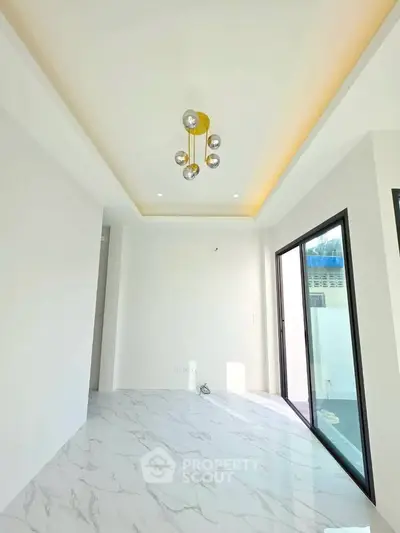 Modern minimalist interior with marble flooring and stylish ceiling light fixture.