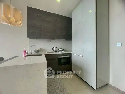 Modern kitchen with sleek cabinetry and built-in appliances in a stylish apartment.