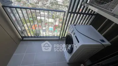 High-rise balcony with washing machine and city view, perfect for urban living convenience.