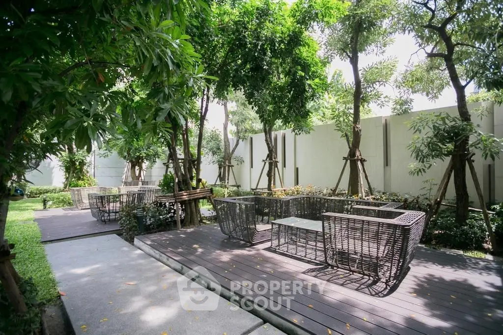 Serene garden area with stylish outdoor seating and lush greenery, perfect for relaxation and gatherings.