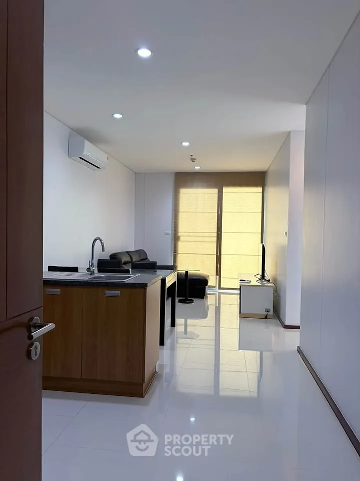 Modern open-plan living room with sleek kitchen and stylish furnishings
