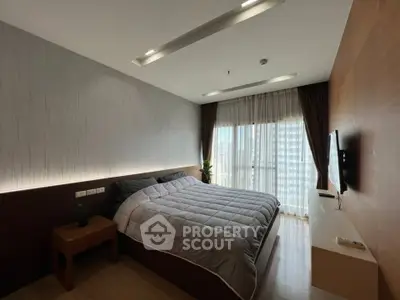 Modern bedroom with large window and stylish decor in a high-rise apartment.