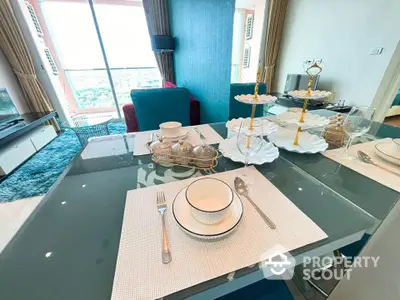 Elegant dining area with city view, modern decor, and stylish table setting in a high-rise apartment.